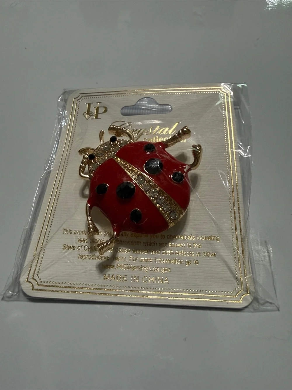 Gold-Tone Red Ladybug Brooch with Crystal Accent